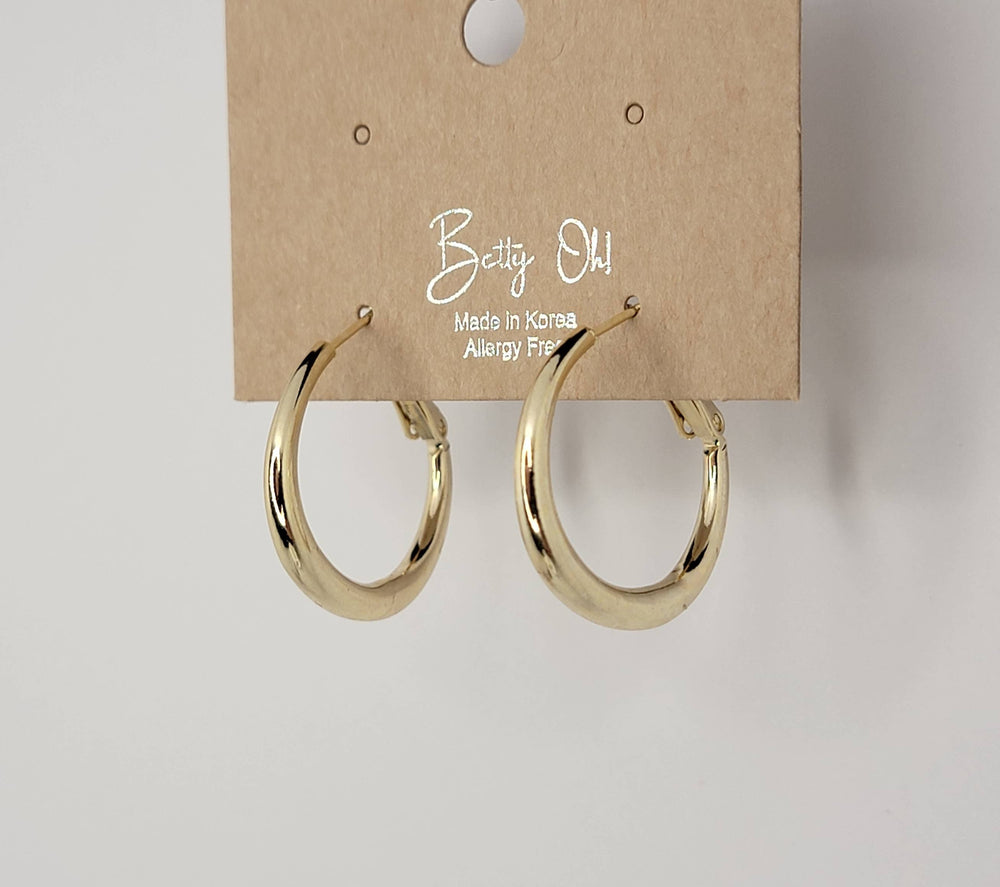 Gold hoop earrings on a 'Betty Oh!' branded card against a white background