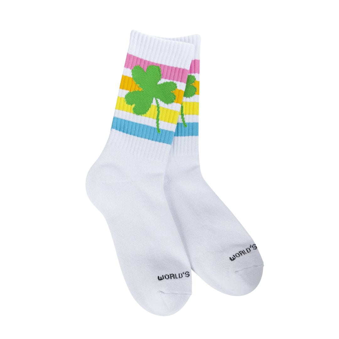 A pair of white athletic socks with colorful horizontal stripes and green shamrock designs on the cuffs.